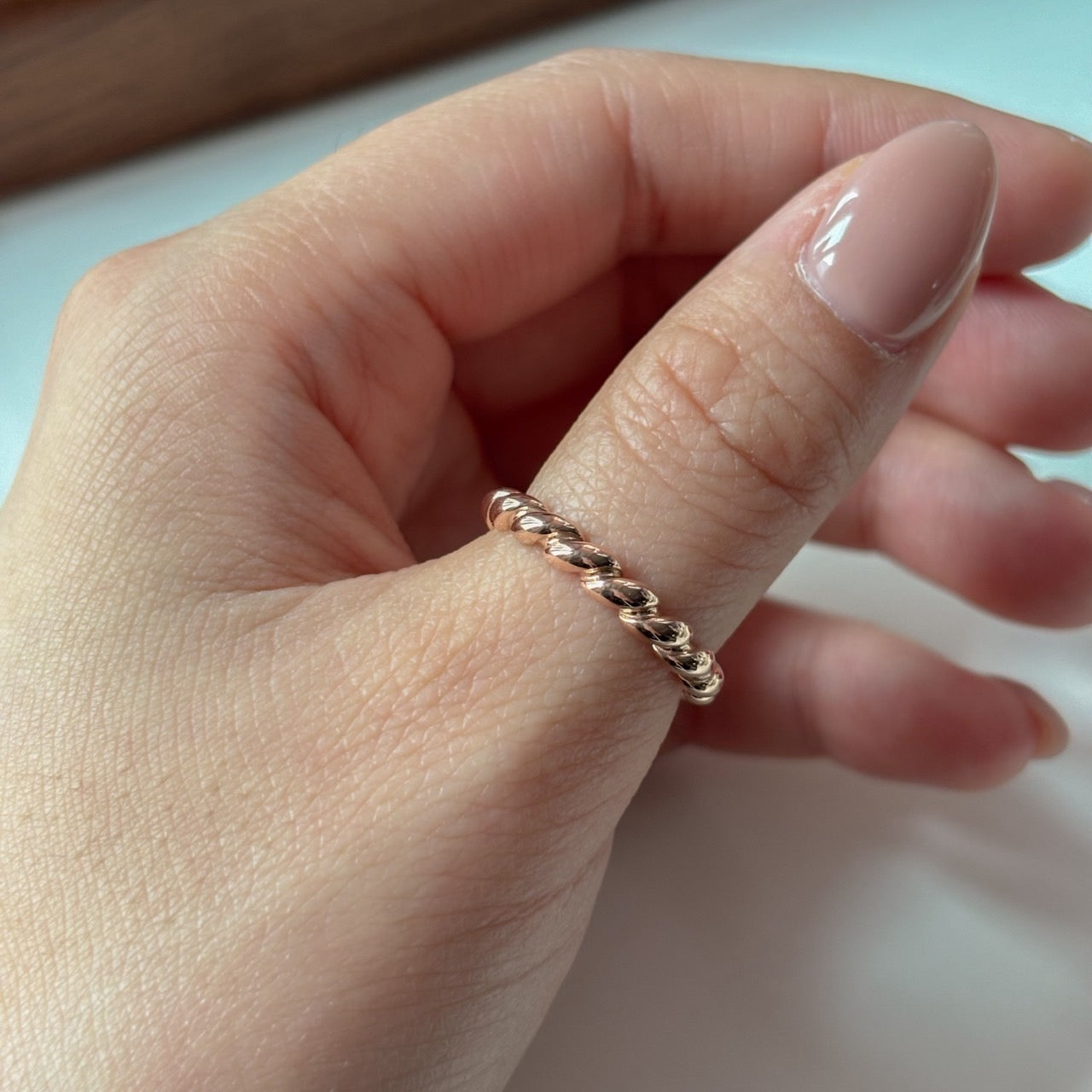 Gold Twist Ring on thumb