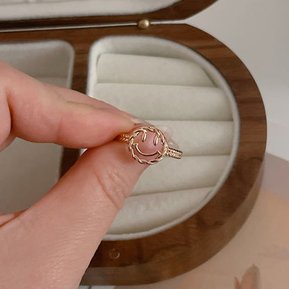 Happy Face Ring being held in hand.
