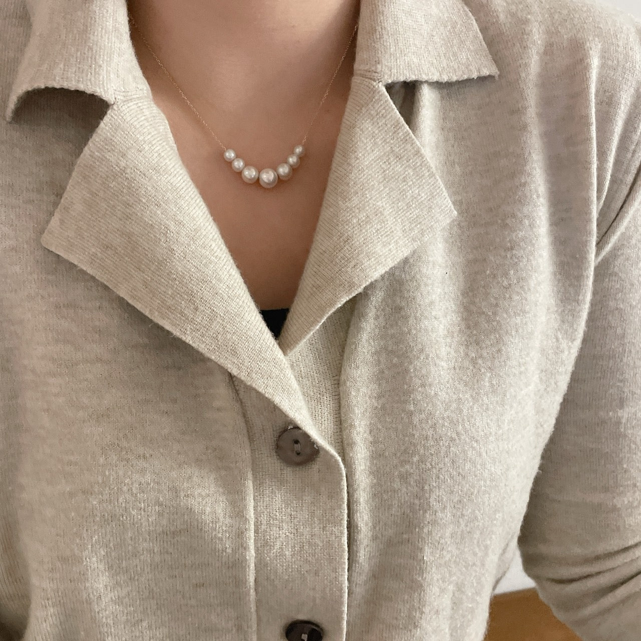 Model wearing 14k solid gold floating pearl necklace